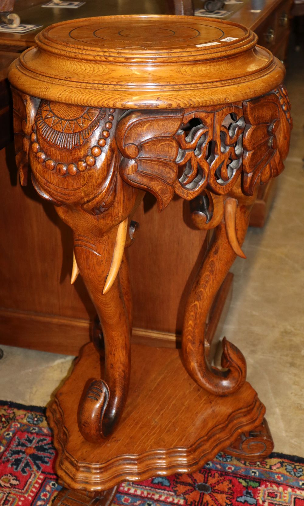 An Indian style carved oak jardiniere stand, H.82cm